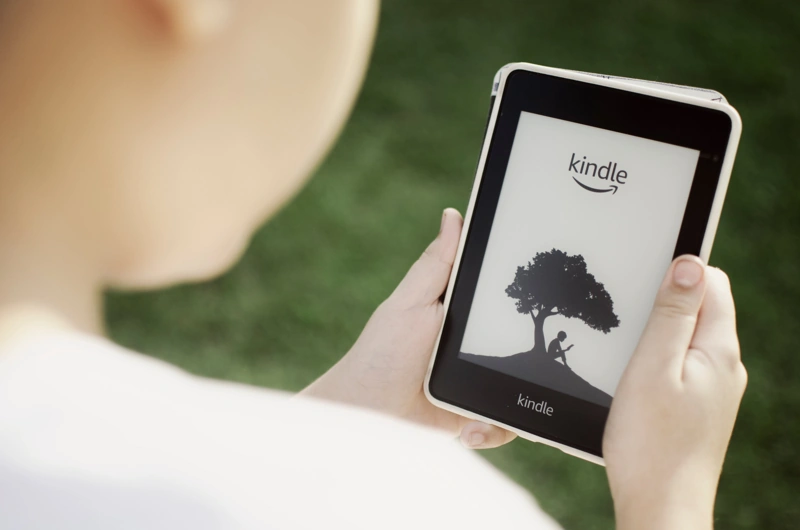 Pessoa se preparando para fazer uma leitura tranquila com o seu Kindle. Falando sobre os melhores livros do Kindle Unlimited.